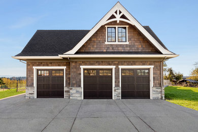 Photo of a large contemporary attached three-car garage in Portland.