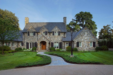 Example of a large classic gray two-story stone exterior home design in Other with a shingle roof