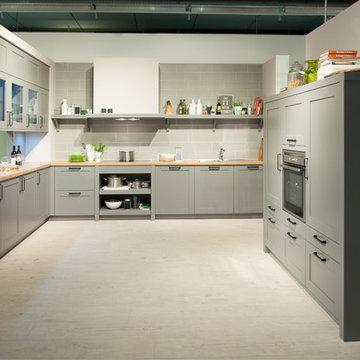 Offene Wohnküche in einem hellen Grau und mit viel Stauraum