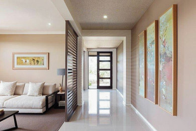 This is an example of a large contemporary front door in Sunshine Coast with beige walls, ceramic floors, a double front door, a brown front door and beige floor.