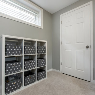 Design ideas for a medium sized traditional look-out basement in Toronto with grey walls, carpet, no fireplace and white floors.