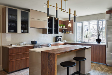 Photo of a contemporary kitchen in Boston with wood worktops and stainless steel appliances.