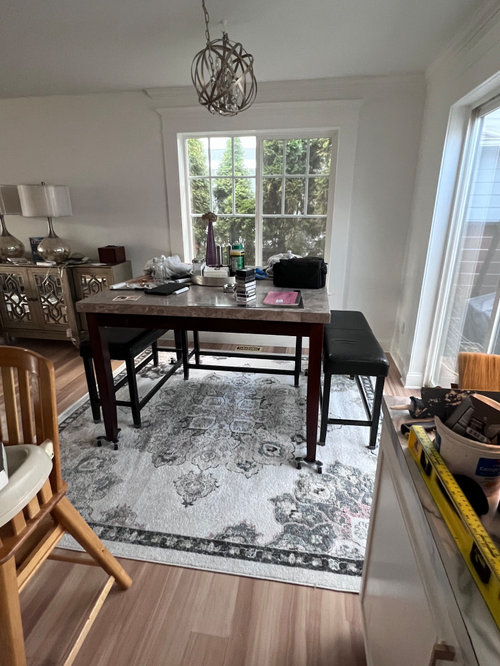 I can’t center dining table on area rug. Rug or no rug?