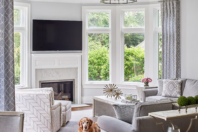Family room - large transitional open concept medium tone wood floor and brown floor family room idea in Charlotte with gray walls, a standard fireplace, a wall-mounted tv and a tile fireplace