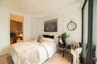 Design ideas for a transitional bedroom in Melbourne with white walls and beige floor.
