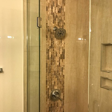 Polished porcelain tile shower with vertical deco band