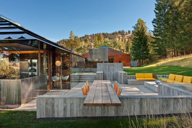 Example of a trendy patio design in Phoenix with a fire pit and no cover
