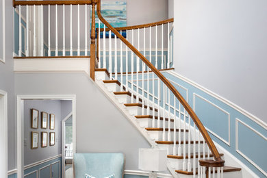 Example of a huge transitional light wood floor entryway design in DC Metro with multicolored walls