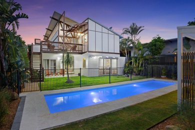 Design ideas for a large backyard custom-shaped lap pool in Gold Coast - Tweed.