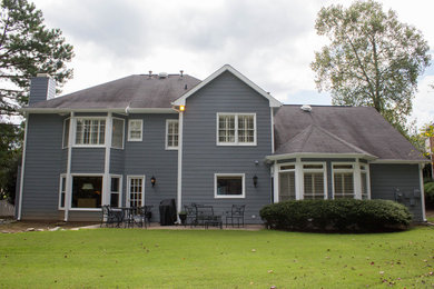 Large elegant gray two-story vinyl gable roof photo in Atlanta