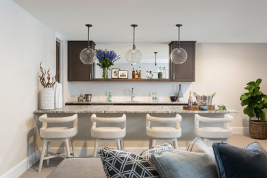 Large transitional single-wall carpeted and beige floor wet bar photo in Denver with an undermount sink, flat-panel cabinets, brown cabinets, granite countertops, white backsplash and gray countertops
