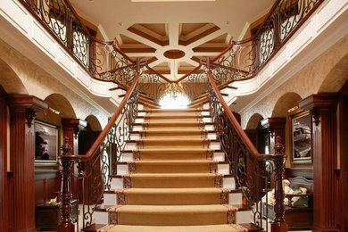 Inspiration for a huge modern carpeted l-shaped wood railing staircase remodel in Orange County with carpeted risers