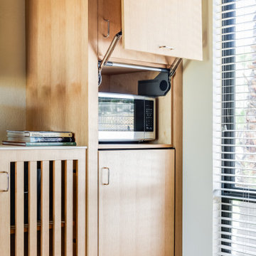 Vertical Lift Up Cabinet Door that Hides Microwave in Home Office