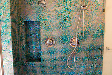 Corner shower - mid-sized eclectic master blue tile and glass tile porcelain tile corner shower idea in Other with flat-panel cabinets, medium tone wood cabinets, a two-piece toilet, beige walls, a vessel sink and wood countertops