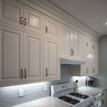 Coastal Kitchen with Custom Classic White Cabinetry and Teal Island