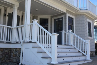 Large elegant front porch photo in Orange County with decking and a roof extension