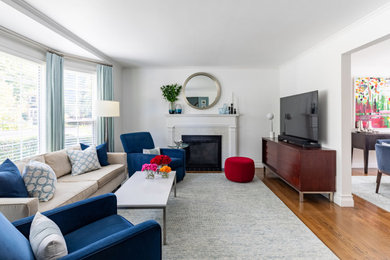 Mid-sized minimalist open concept medium tone wood floor and brown floor living room photo in Chicago with white walls, a standard fireplace, a wood fireplace surround and a tv stand