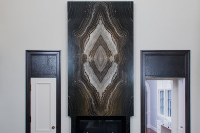 Example of a large trendy formal and open concept carpeted living room design in Boston with beige walls, a standard fireplace, a stone fireplace and a media wall