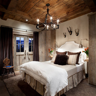 This is an example of a rustic guest bedroom in Atlanta with beige walls.