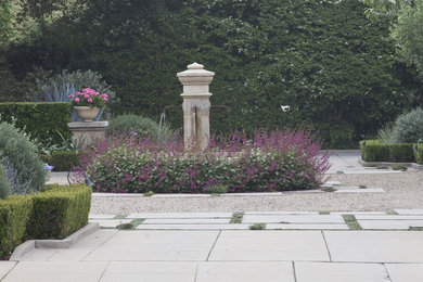 Photo of a large mediterranean full sun front yard stone landscaping in Los Angeles.