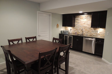 Example of a mid-sized classic look-out carpeted basement design in Detroit with gray walls