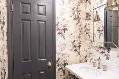 Powder room - ceramic tile and multicolored floor powder room idea in Toronto with a two-piece toilet, multicolored walls, an undermount sink, quartz countertops and white countertops