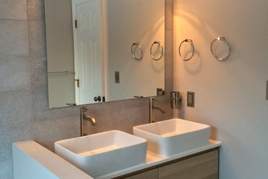 Bathroom - mid-sized modern master bathroom idea in New York with flat-panel cabinets, medium tone wood cabinets, white walls, a vessel sink and quartzite countertops