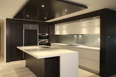 Photo of a large contemporary l-shaped eat-in kitchen in Vancouver with a drop-in sink, white cabinets, grey splashback, stainless steel appliances and with island.