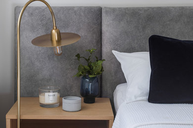 Design ideas for a medium sized scandinavian master bedroom in London with grey walls, dark hardwood flooring, no fireplace and brown floors.
