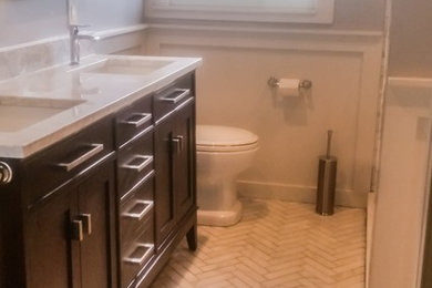 Inspiration for a mid-sized timeless 3/4 white tile and stone tile marble floor bathroom remodel in Austin with recessed-panel cabinets, dark wood cabinets, gray walls, an undermount sink and marble countertops