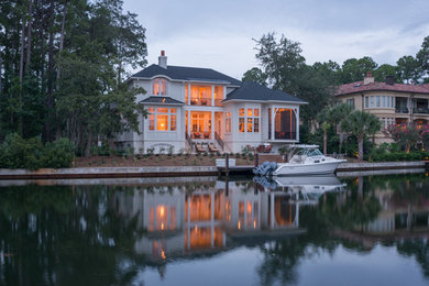 Huge transitional white two-story wood exterior home photo in Atlanta with a hip roof