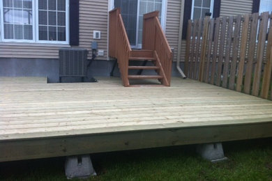 Example of a mid-sized trendy backyard deck design in Ottawa with no cover