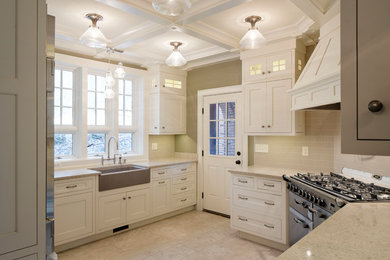 Example of a classic multicolored floor and porcelain tile kitchen design in Other with a farmhouse sink, shaker cabinets, white cabinets, quartz countertops, subway tile backsplash, stainless steel appliances, beige backsplash, a peninsula and beige countertops