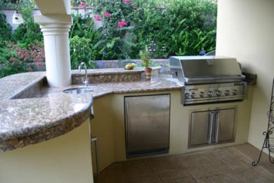 Inspiration for a timeless stamped concrete patio kitchen remodel in Los Angeles with a gazebo