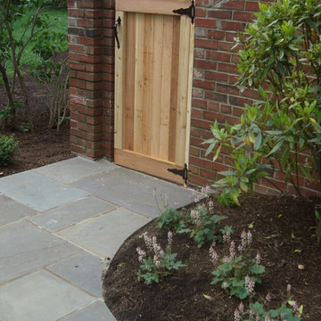 Cedar gate and brick wall