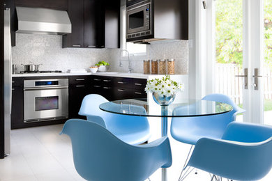 Example of a trendy u-shaped eat-in kitchen design in Toronto with an undermount sink, flat-panel cabinets, dark wood cabinets, quartz countertops, white backsplash, mosaic tile backsplash and stainless steel appliances