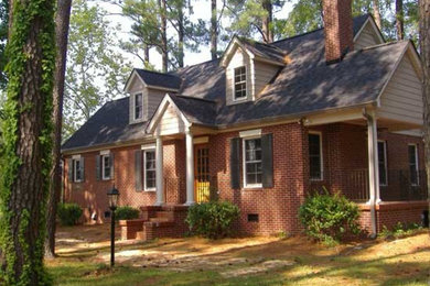 Inspiration for a mid-sized timeless brown two-story brick gable roof remodel in Atlanta
