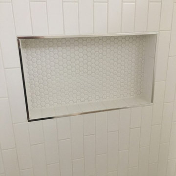 Secondary bathrooms. Love the chrome trim by Schluter. Much cleaner look than bu