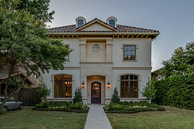 Example of a large tuscan white three-story exterior home design in Dallas