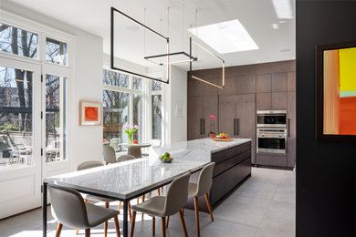 Large trendy l-shaped porcelain tile and gray floor eat-in kitchen photo in Toronto with a double-bowl sink, flat-panel cabinets, dark wood cabinets, marble countertops, white backsplash, marble backsplash, stainless steel appliances, an island and white countertops