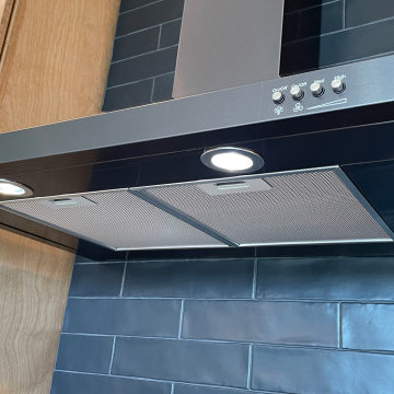 Angled Kitchen Design with Slab Style Cabinets in Pecan Stain