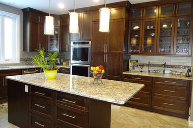 Inspiration for a mid-sized timeless limestone floor enclosed kitchen remodel in Other with shaker cabinets, dark wood cabinets, granite countertops, beige backsplash, subway tile backsplash, stainless steel appliances and an island