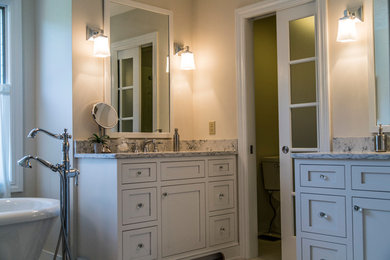Freestanding bathtub - mid-sized transitional master gray tile freestanding bathtub idea in Cleveland with shaker cabinets, white cabinets, a one-piece toilet, beige walls and marble countertops