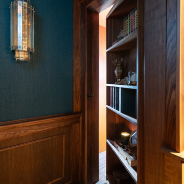 Custom Hidden Bookcase Door Integrated into Walnut Media Room Millwork