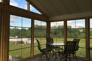 Inspiration for a mid-sized arts and crafts backyard screened-in verandah in San Diego with decking and a roof extension.