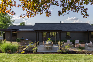 French country gray vinyl house exterior photo in Cleveland with a shingle roof and a black roof