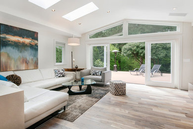 Living room - mid-sized transitional formal and open concept light wood floor living room idea in Vancouver with white walls, a two-sided fireplace, a metal fireplace and a wall-mounted tv