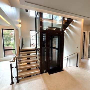Project #136 | Modern Floating Staircase Encircling Glass Elevator