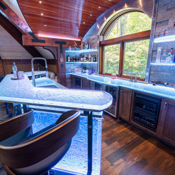 Glass private bar and glass stair treads inside a man cave in Michigan