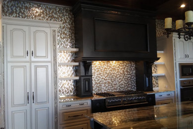 Mid-sized ornate kitchen photo in Orlando with a farmhouse sink, raised-panel cabinets, white cabinets, multicolored backsplash, glass tile backsplash, stainless steel appliances and two islands